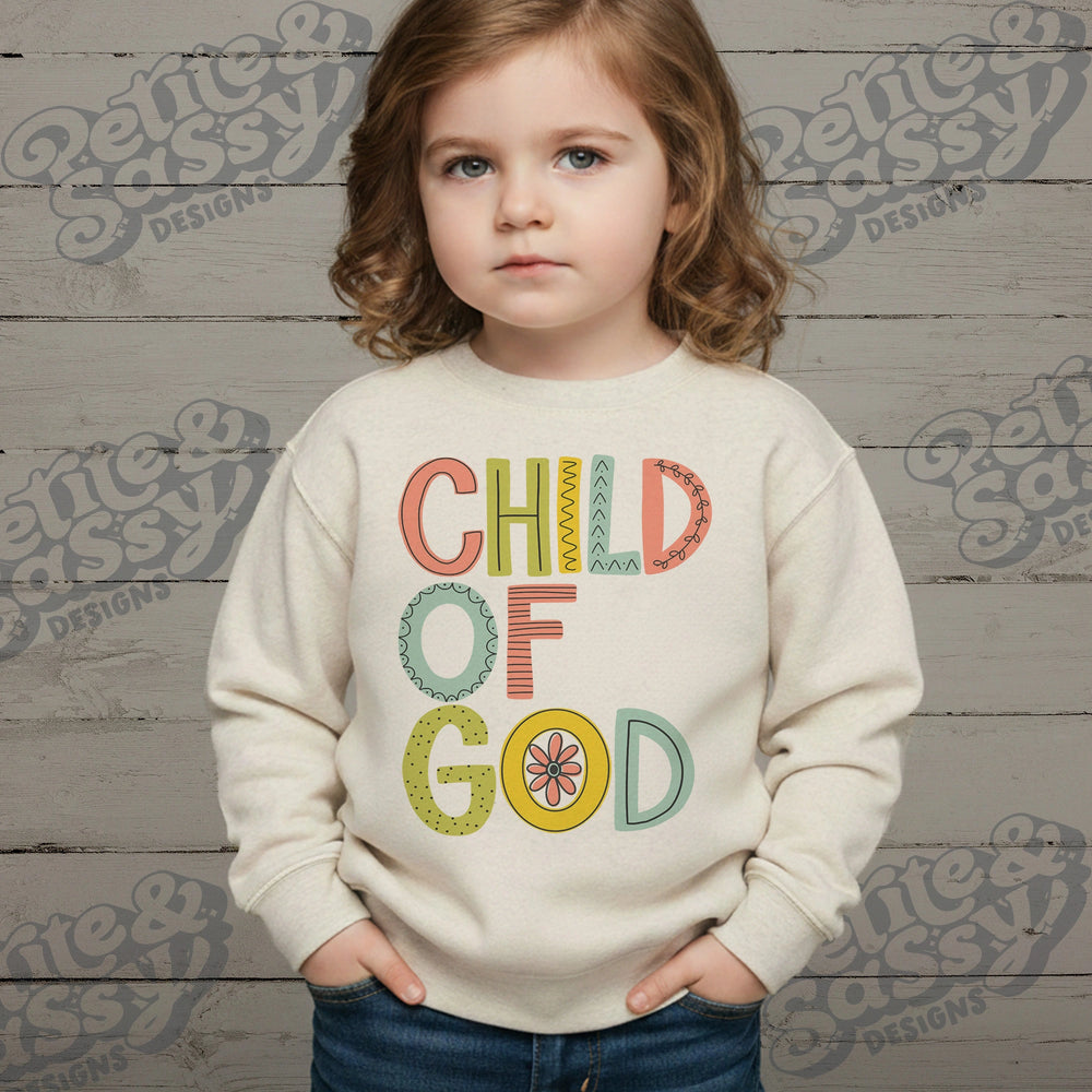 Folded sweatshirt with 'Child of God' text on a light background