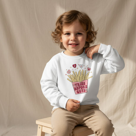 Child wearing a white sweatshirt with a fries before guys graphic design on a beige background