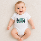 Baby wearing a white onesie with 'BUBS' print on a light background