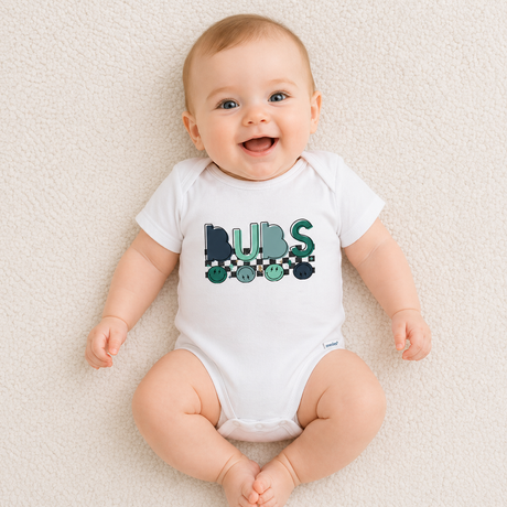 Baby wearing a white onesie with 'BUBS' print on a light background