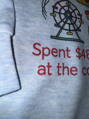 Close-up of a light heather gray sweatshirt featuring a colorful graphic of a Ferris wheel and red text that reads 'Spent $48 last night at the county fair"