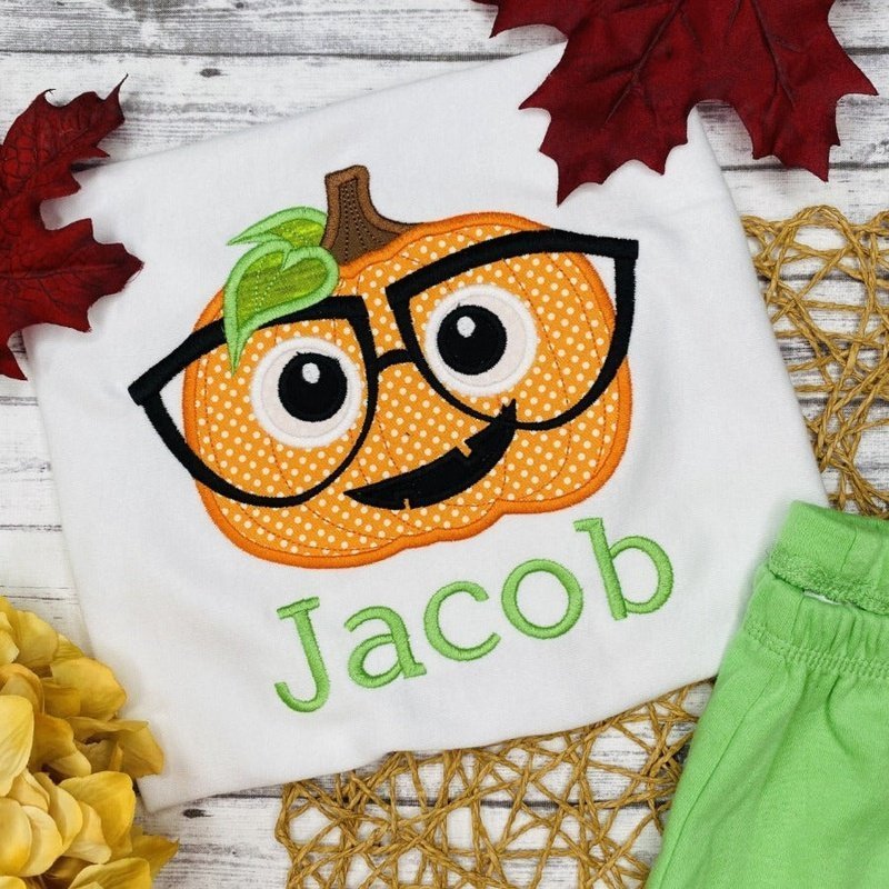 Smart Pumpkin with Glasses - Petite & Sassy Designs face monogram tee,smiling pumpkin top,girls jack o lantern,1st halloween tee,applique shirt,girls pumpkin tee,halloween monogram,halloween pumpkin,halloween shirt,jack o lantern tee,pumpkin applique,pumpkin face,pumpkin face shirt